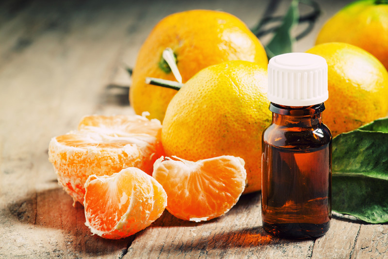 essential oil bottle with oranges