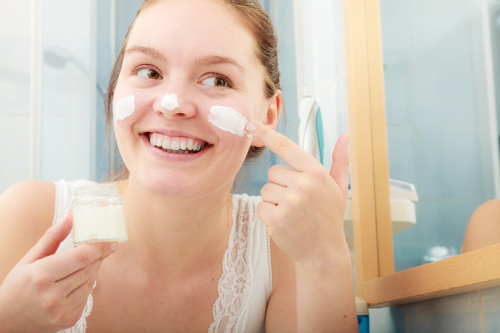 Woman applying moisturising skincare cream