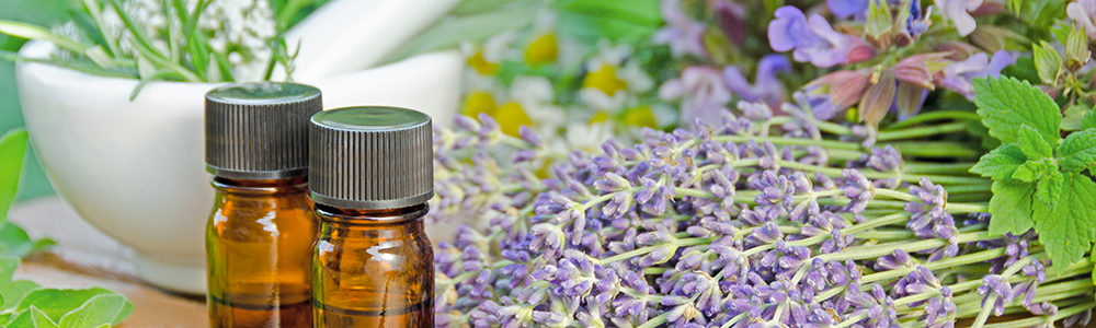 essential oils with herbal flowers for aromatherapy treatment
