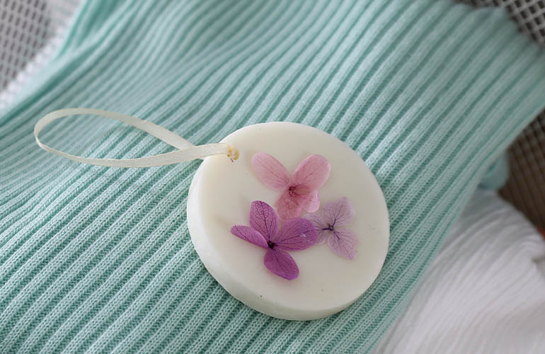 Scented floral disc on top of laundry